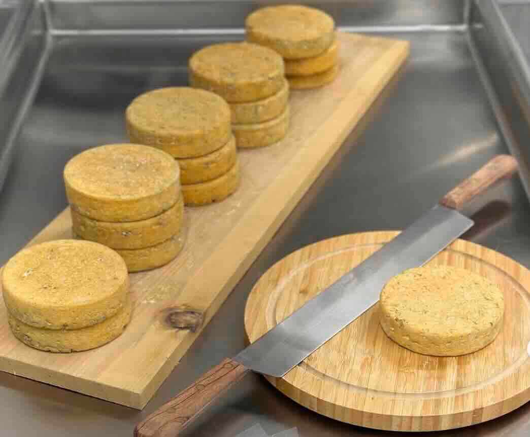 A washed rind cheese with citrus notes. The milk is infused with a coriander tea before being cultured. The coriander seeds are added to the curd right before putting in forms. After being lightly pressed and brined, the cheeses will head to our cave where they will be washed with beer and age for 60 days. Semi-soft texture. Melts very well. Best enjoyed with a beer! The rind is absolutely edible!