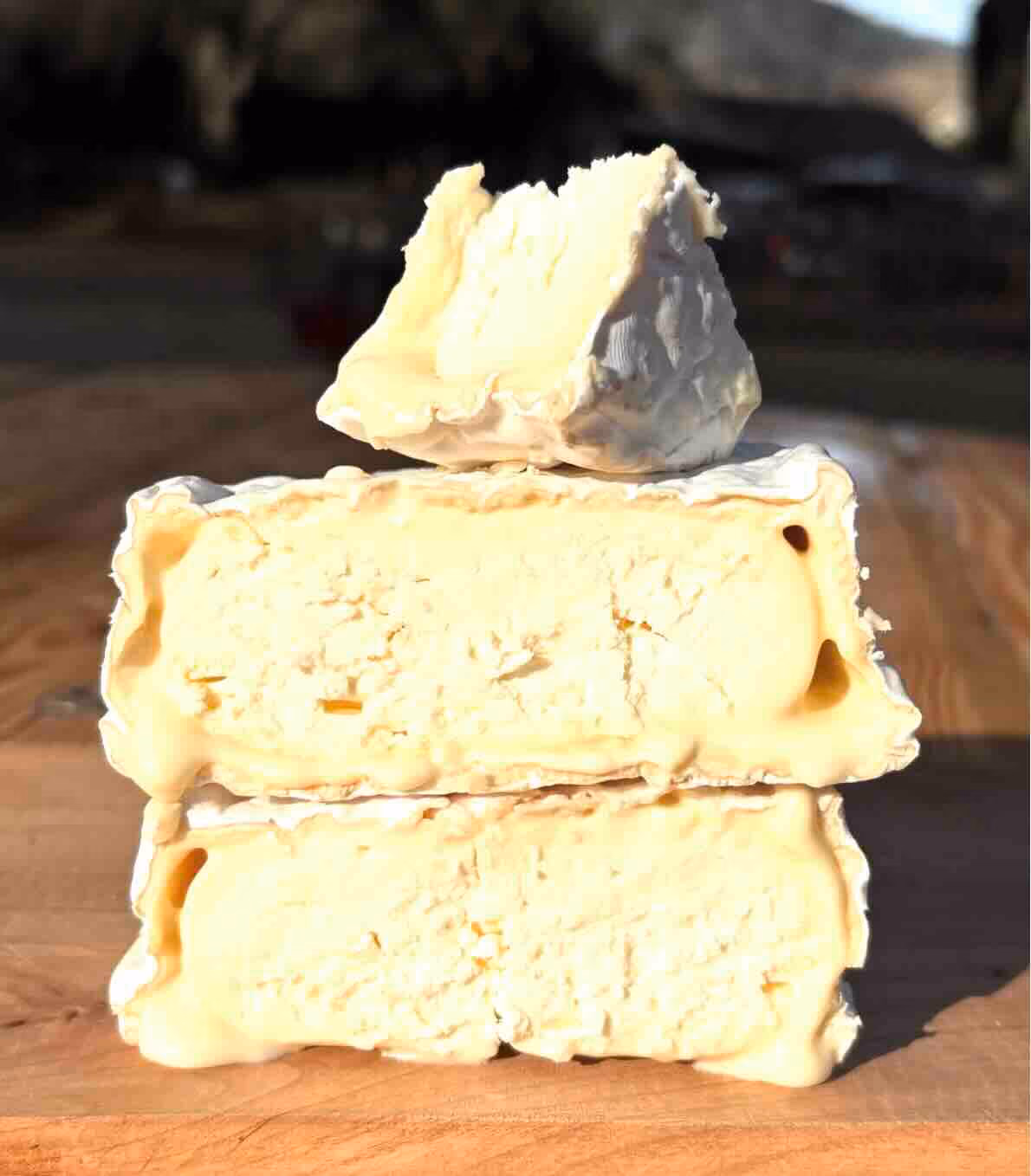 This Camembert-style bloomy rind cheese is lightly dusted with ash and aged for three weeks. It has a smooth texture with subtle mushroom notes, making it an excellent pairing with red wine. Currently produced in very small batches, it will be available weekly in the future.