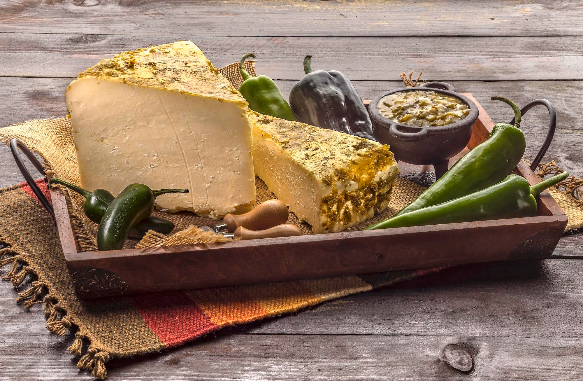 White cheddar cheese rubbed with green salsa ingredients. 