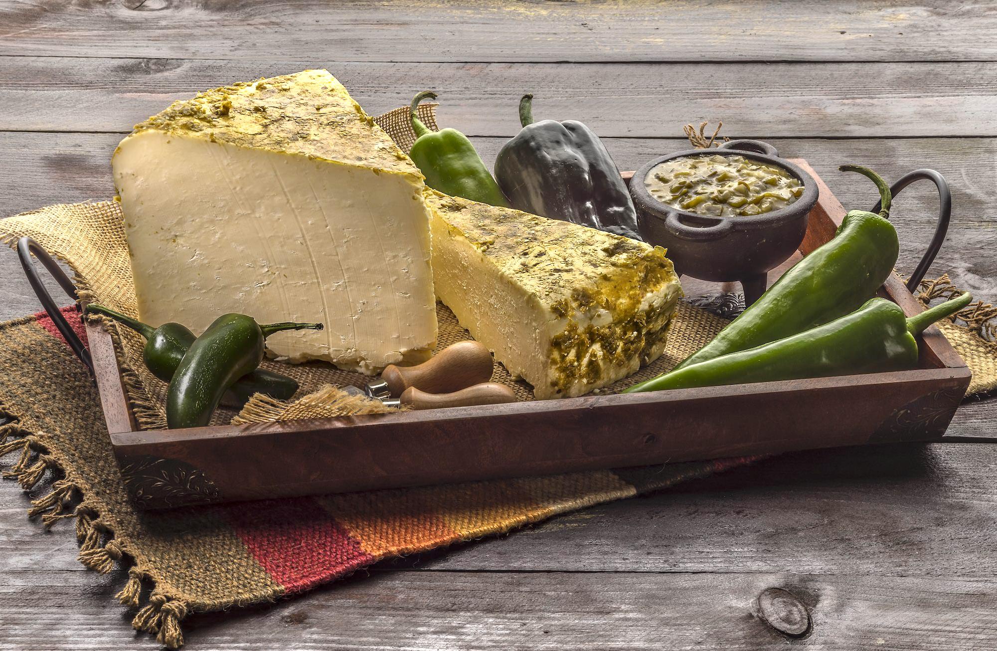 White cheddar cheese rubbed with green salsa ingredients. 