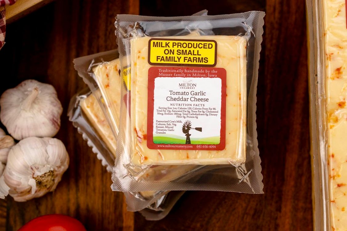 Tomato Garlic Cheddar is a creamy, handcrafted cheddar infused with real tomatoes and garlic for a savory, well-balanced flavor that’s perfect for sandwiches, melting, and charcuterie boards.