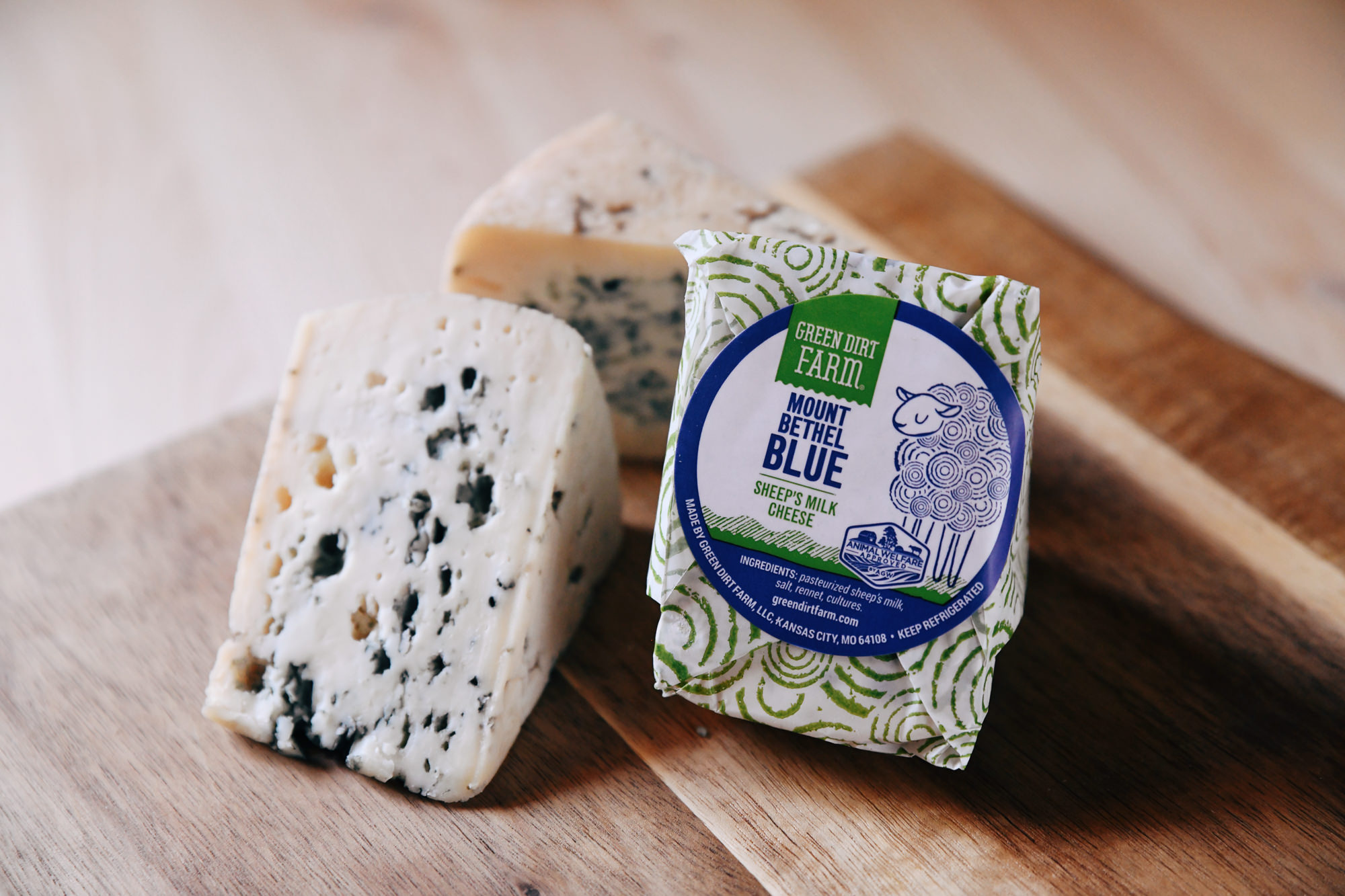 An image of Green Dirt Farm's Mount Bethel Blue cheese in wrapped and unwrapped wedges