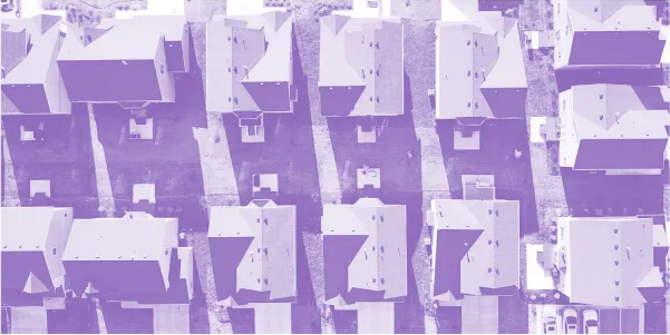 Aerial view of a residential neighborhood with uniformly aligned houses and driveways.