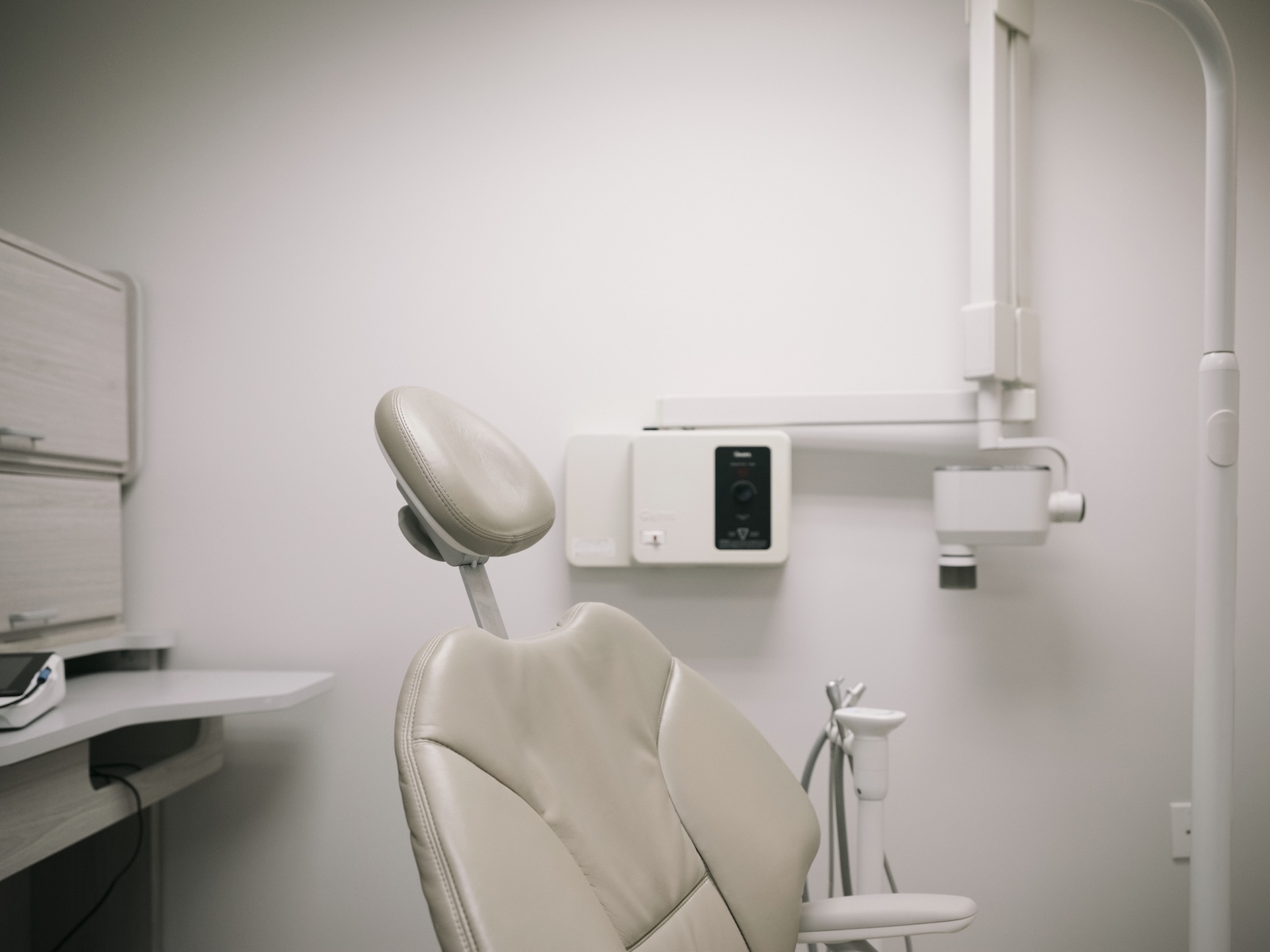 Clean modern dental exam room with chair and digital X-ray equipment at Decker Dental.