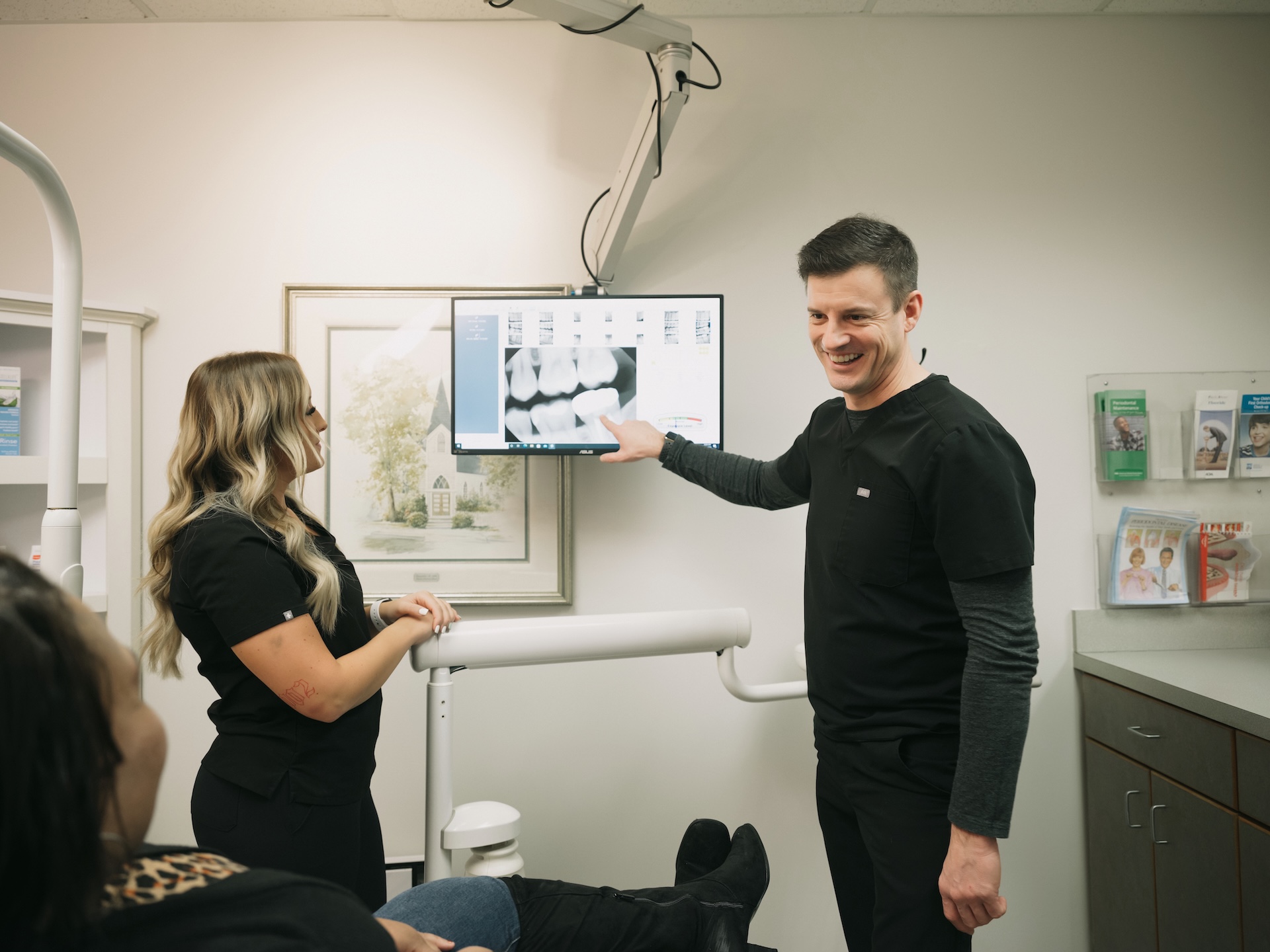 Decker Dental dentist showing a x-ray of a patient's crown placement.