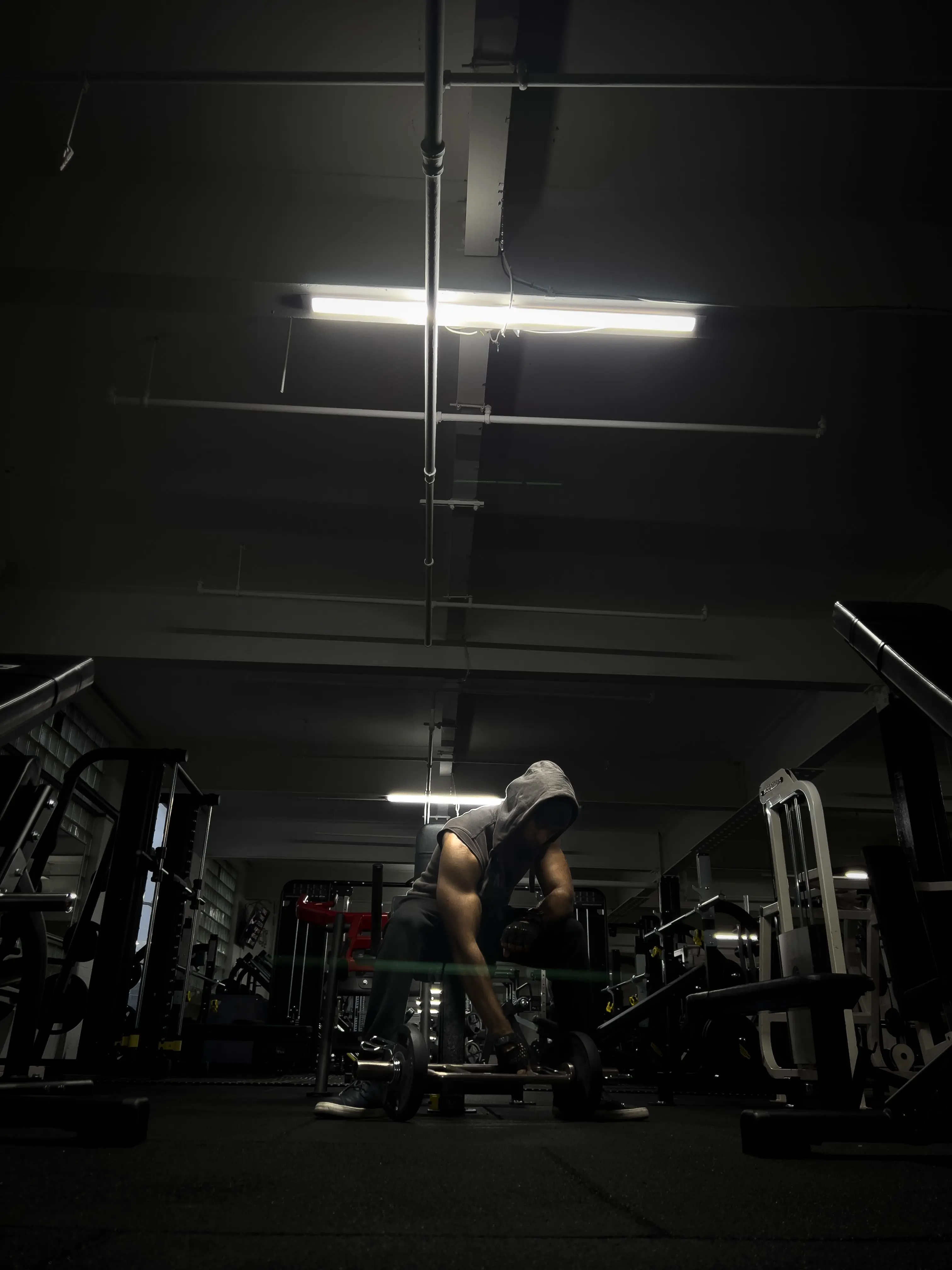 Man sitting surrounded by weights