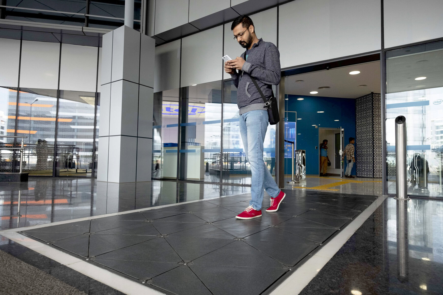 A man walks across a solar-powered sidewalk.