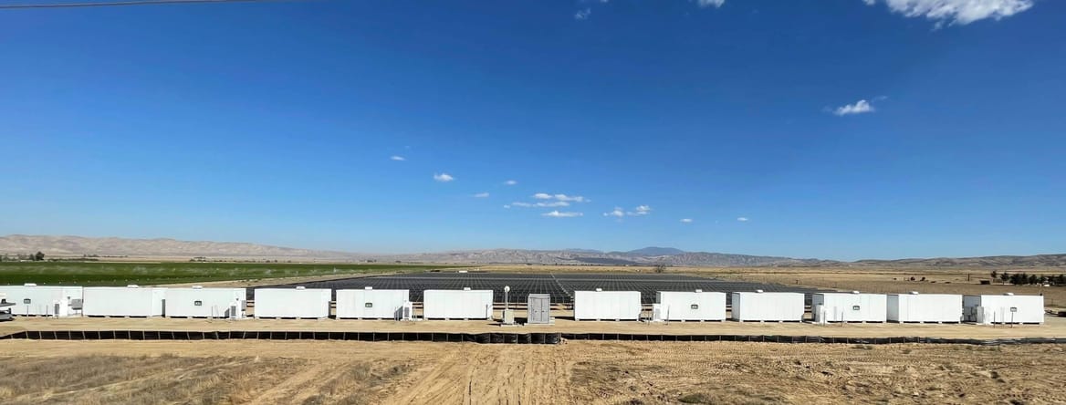 Landscape shot of large white boxes in a stretch of open land