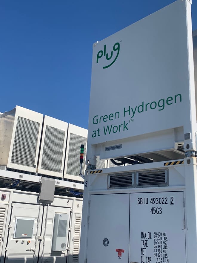 White fuel cell with Plug Power logo and the text "Green Hydrogen at Work"