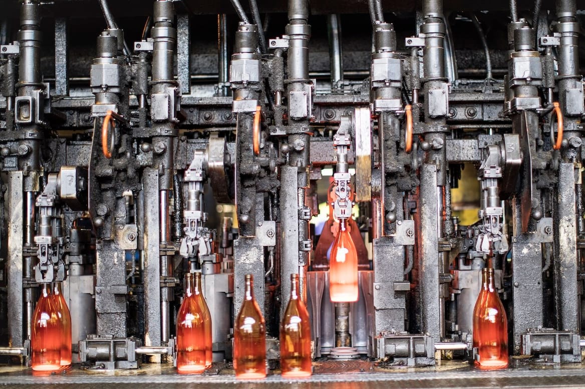 Glass wine bottles being processed by industrial equipment