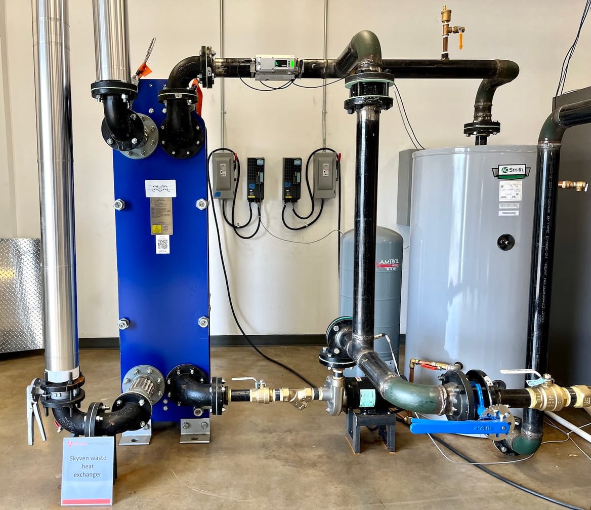 Two metal chambers connected by piping