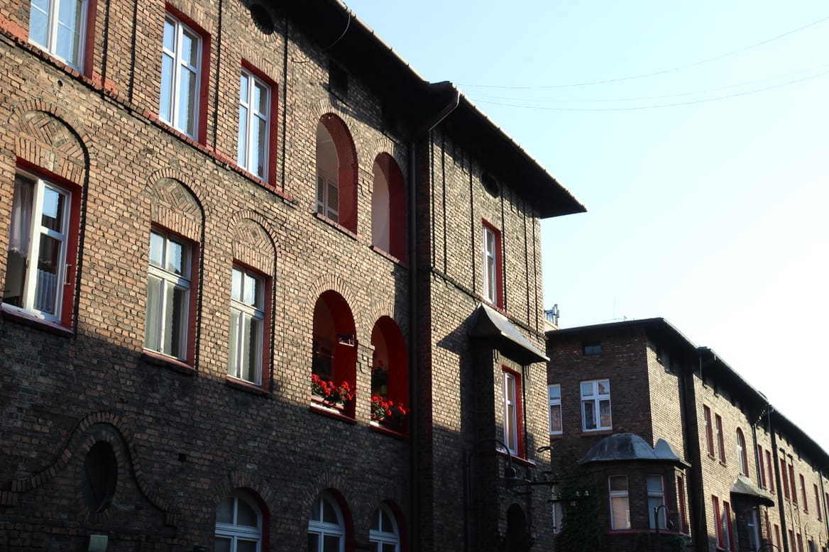 Rows of neat, red brick buildings against a blue sky