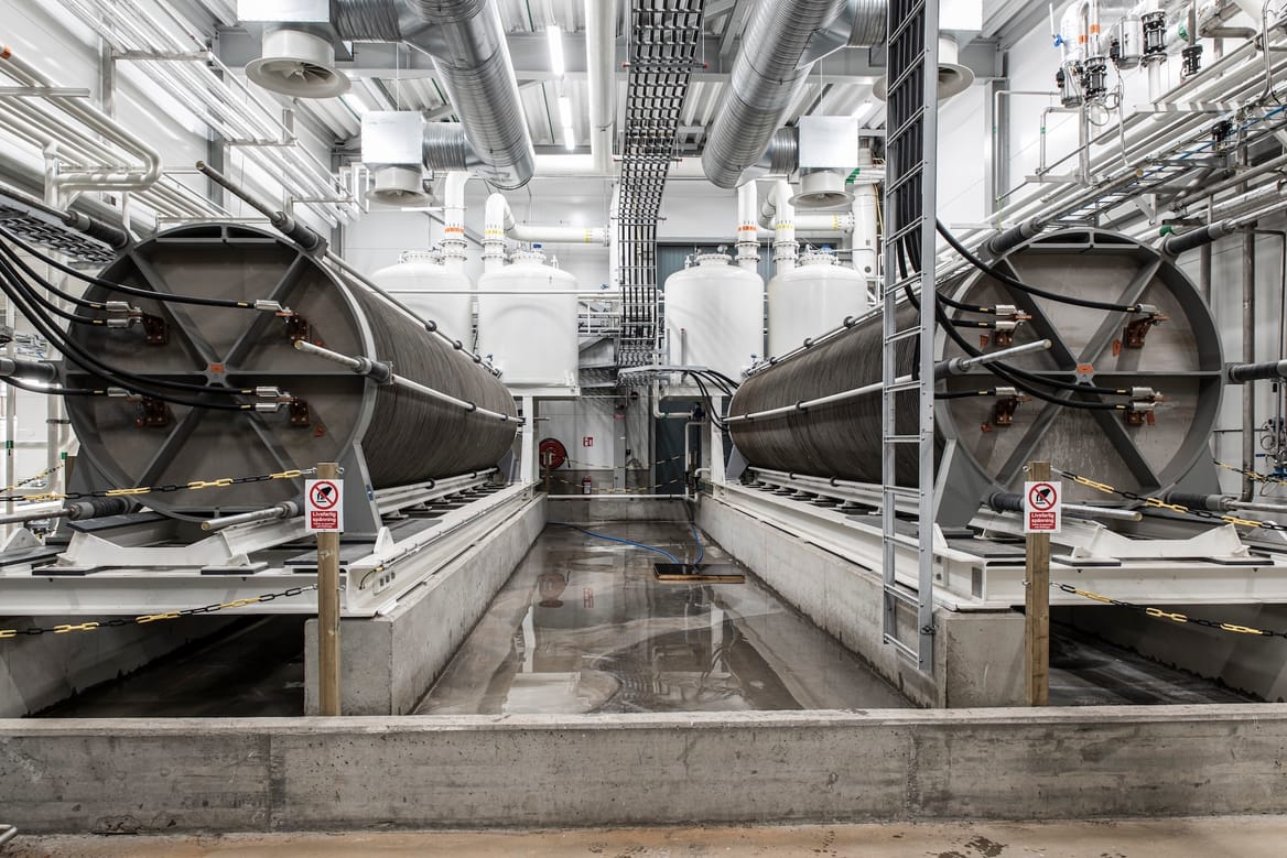 Two electrolyzers on a concrete floor, walls and ceiling of white