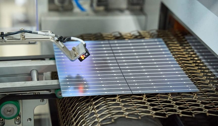 A solar panel component being manufactured