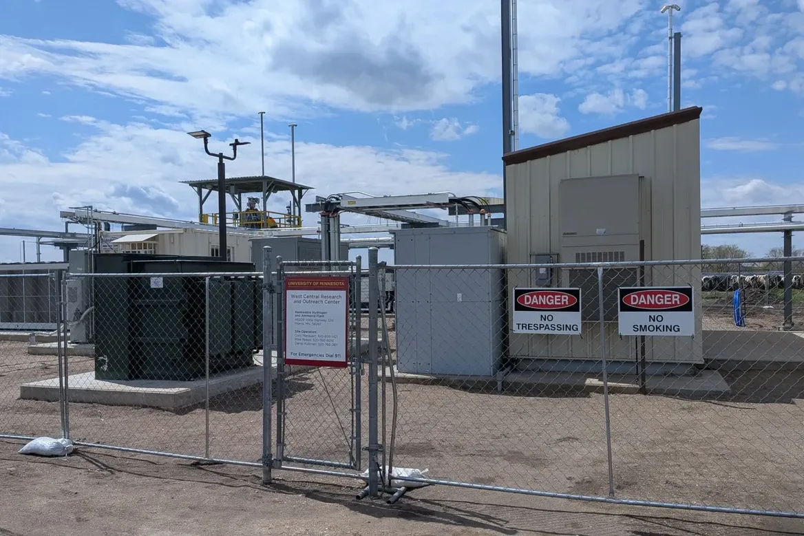Shed and equipment behind fence with "Danger: No Trespassing" signs