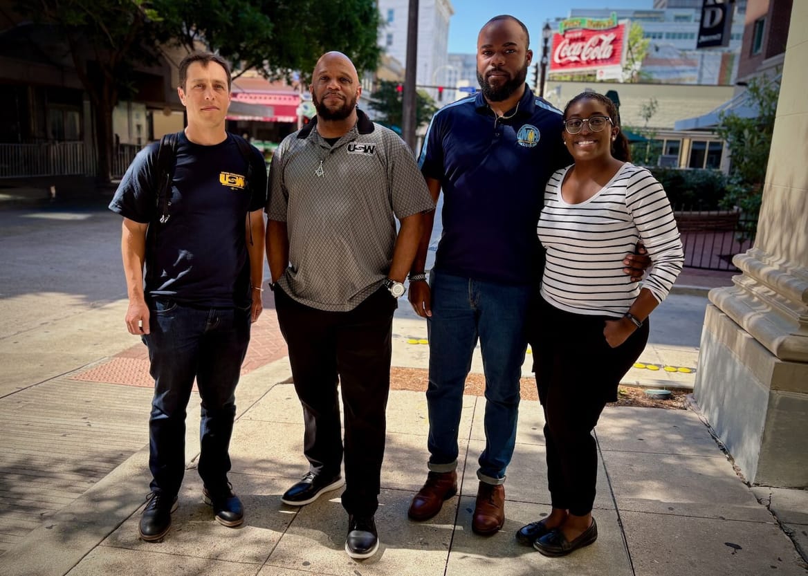 Four people on a city sidewalk