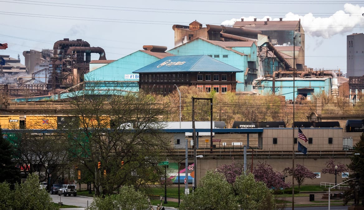 Steel mill with green siding and roofs in center buildings