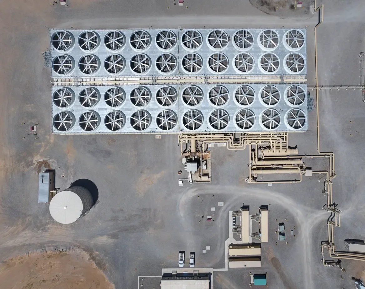 Overhead view of geothermal site with rows of circular cooling towers