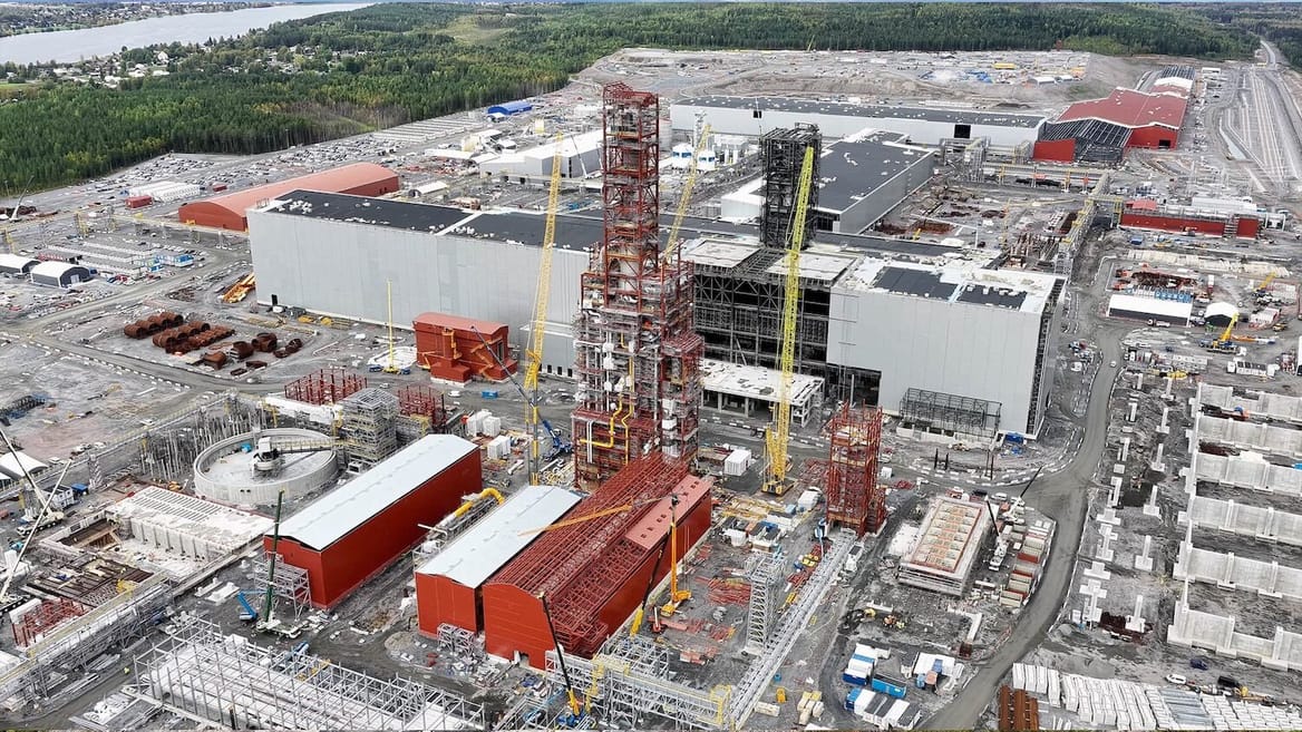 Overhead shot of large steel operation, with orange and gray/white buildings