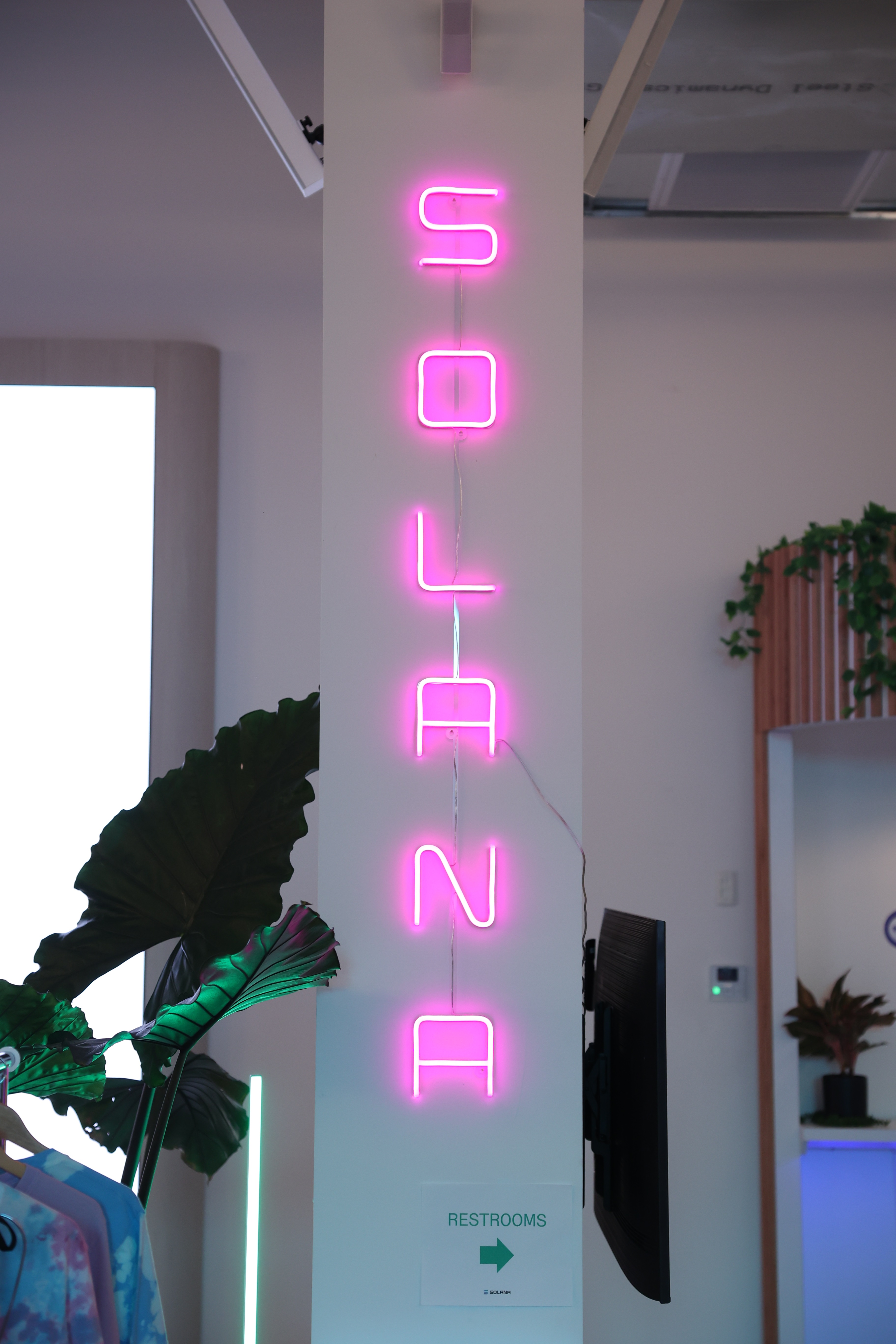 a neon sign that says Solana. Its pink