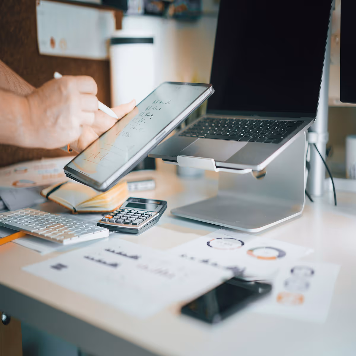 A person is writing on a tablet computer.