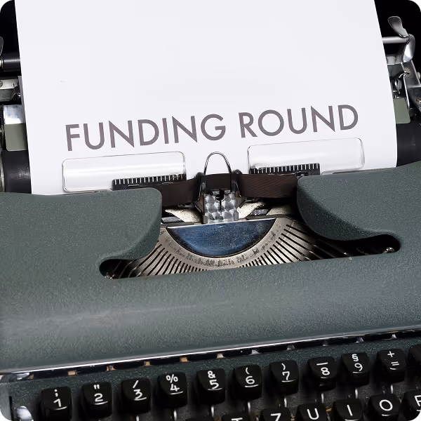 A typewriter with the words Funding Round on the paper.