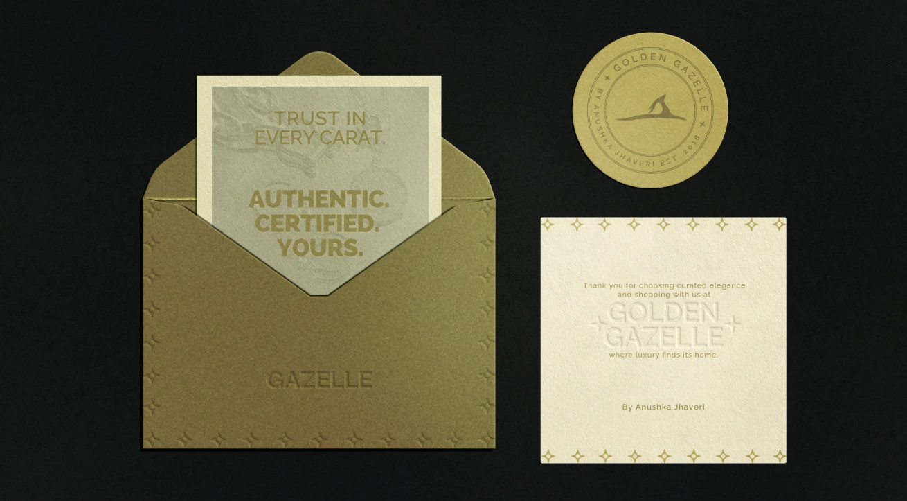 This image showcases the elegant brand packaging design of Golden Gazelle by Anushka Jhaveri. It features a luxurious gold envelope embossed with delicate star patterns, a circular logo seal, and a certification card with the tagline “Trust in every carat. Authentic. Certified. Yours.” The minimalist composition and refined typography reflect the brand’s commitment to authenticity, craftsmanship, and understated opulence. The tactile textures, warm gold tones, and embossed finishes convey sophistication, making it a perfect representation of premium jewellery branding where luxury meets trust and timeless design.
