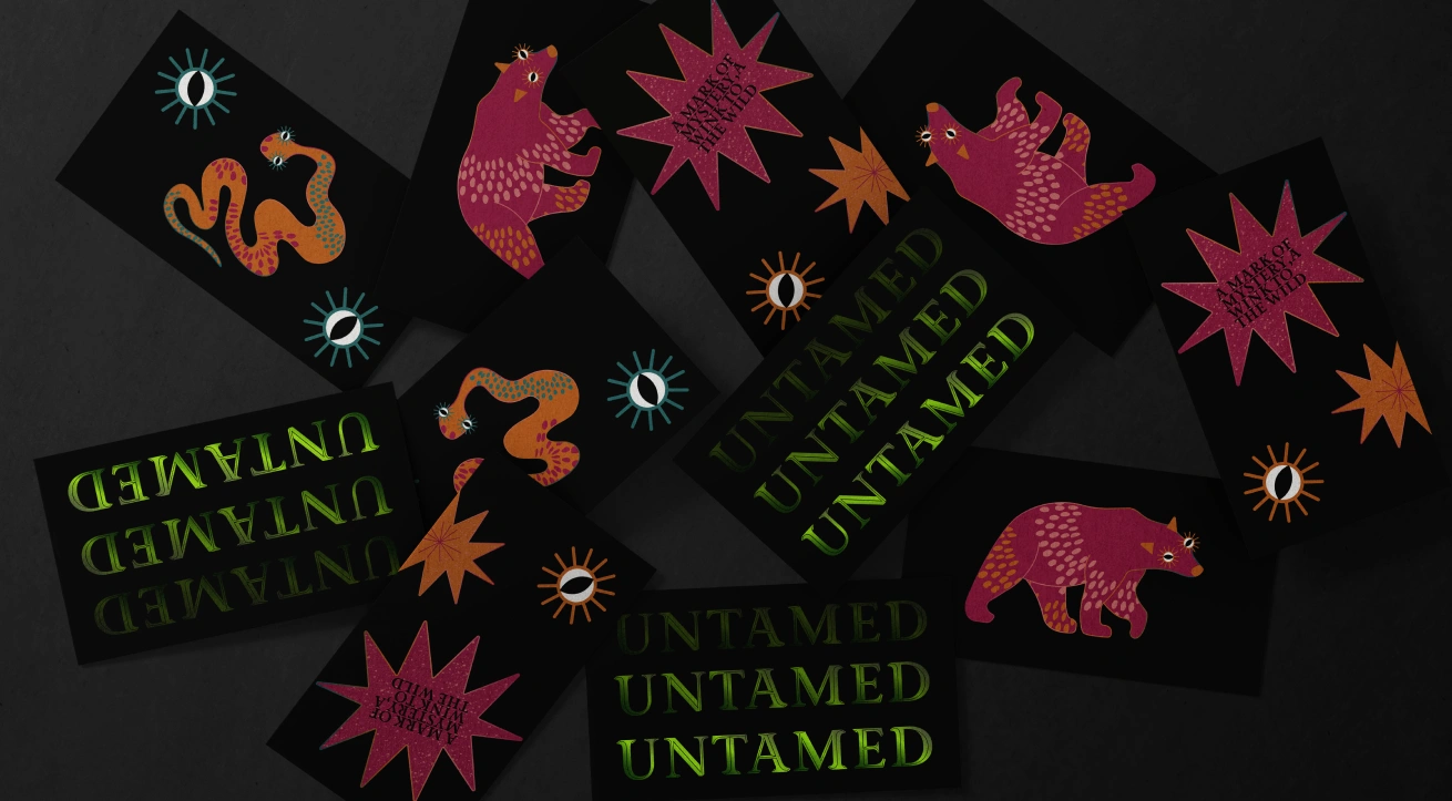 Collection of Untamed Gin brand cards featuring mystical illustrations of snakes, bears, celestial eyes, and stars in bold, colourful designs. The artwork blends folklore-inspired characters with a modern craft aesthetic, reinforcing Untamed’s wild, artistic, and premium alcohol branding.