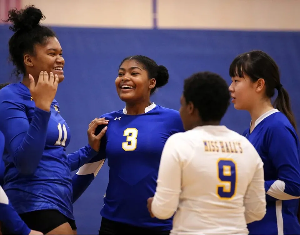 Girls on Miss Hall's School volleyball team celebrate a point.