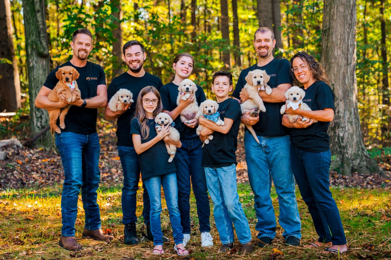 Marcellus, Hannah and the Buckeye Golden Retrievers family holding golden retriever puppies