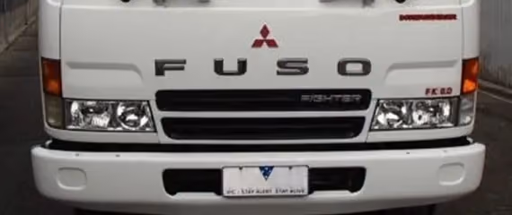 The front of a white Fuso truck.
