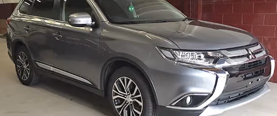 The side view of a grey vehicle.