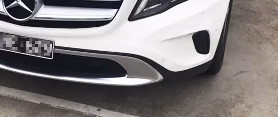 Showcases a Mercedes after extensive repair work, highlighting the restored glossy finish.