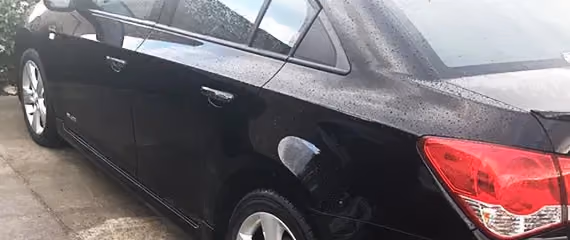 Depicts a Chevrolet Cruze after repair, focusing on the impeccable paint job and detailing.