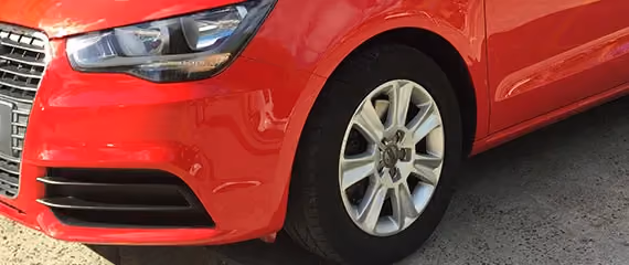 Image of a red Audi after repair, showcasing the car’s vibrant finish and flawless exterior.