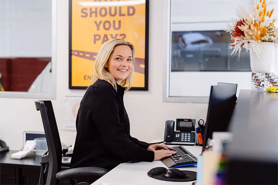Woman working on the computer inside the Sheen officespace.