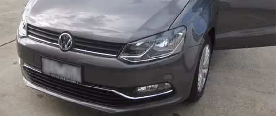 Repaired front view of a blue VW Golf.