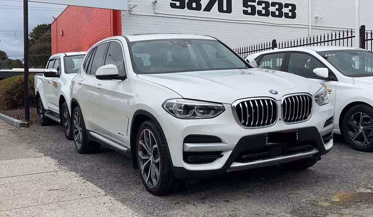 Image of a BMW X5 after professional repair, showcasing the vehicle's luxurious and polished exterior.