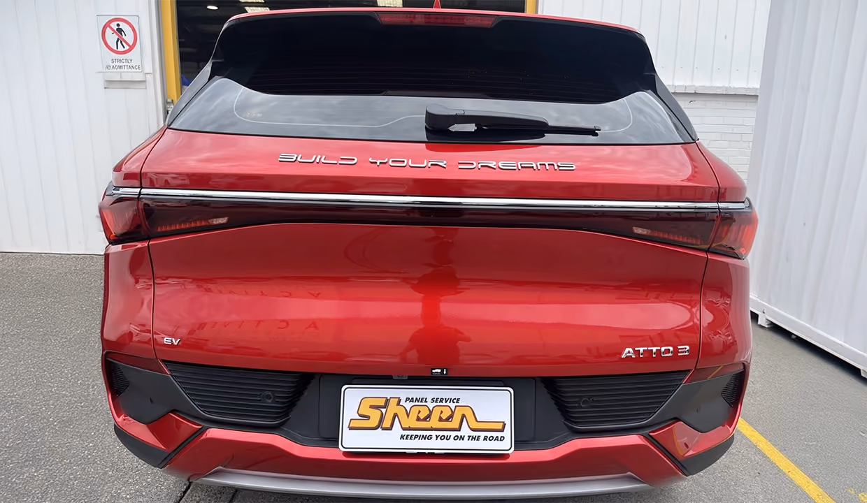 Shows a BYD ATTO 3 after professional repair, featuring a flawlessly restored tailgate, reinstalled trim, and a clean, factory-finish look.