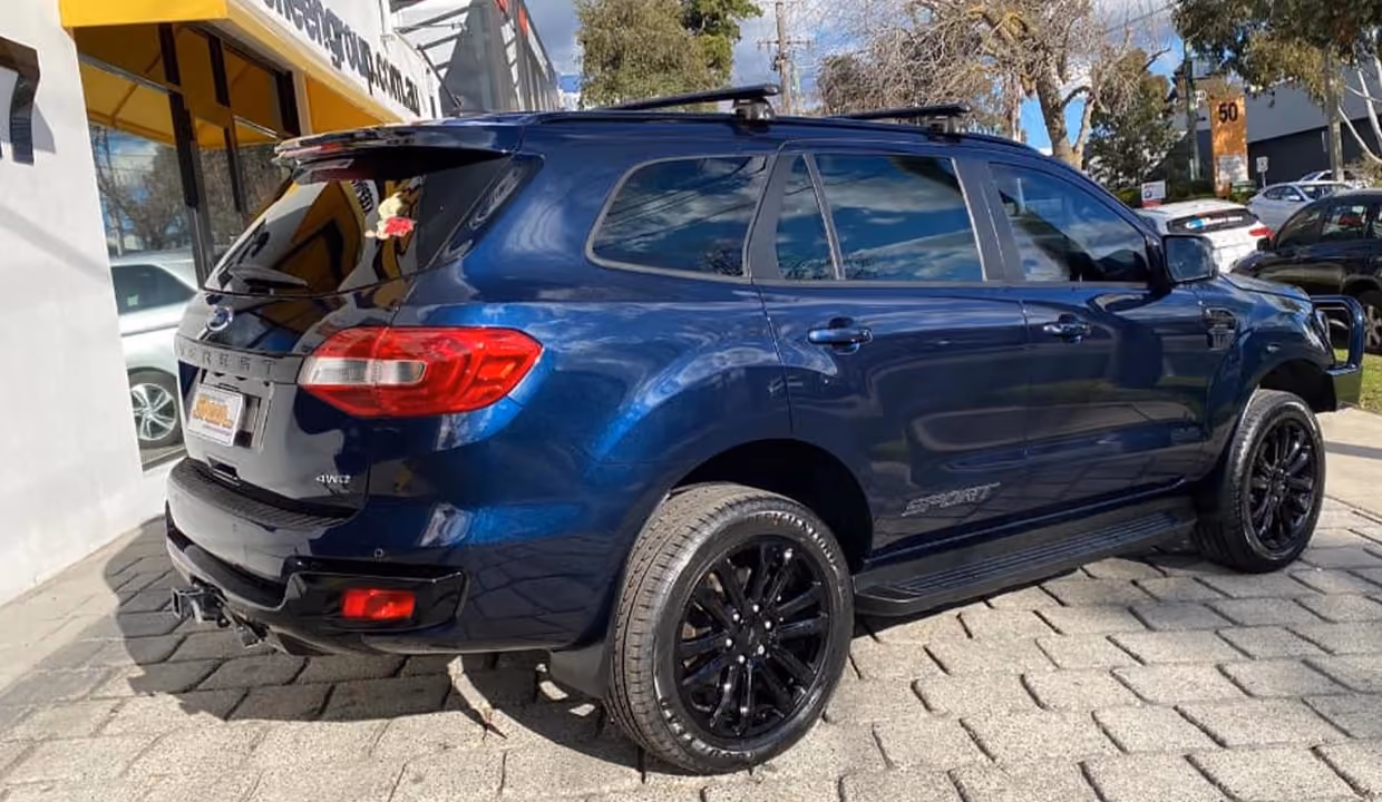Shows a Ford Everest after repair, with the rear panel and bumper fully restored to original condition, featuring a smooth finish and freshly polished surface.