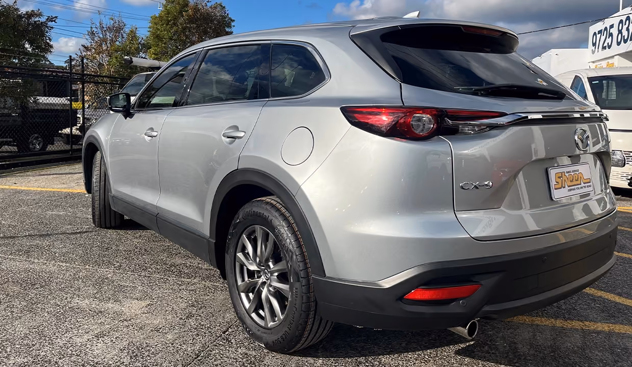 Displays a Mazda CX-9 after repair, fully restored with smooth, undamaged panels and a clean finish that seamlessly matches the original bodywork.