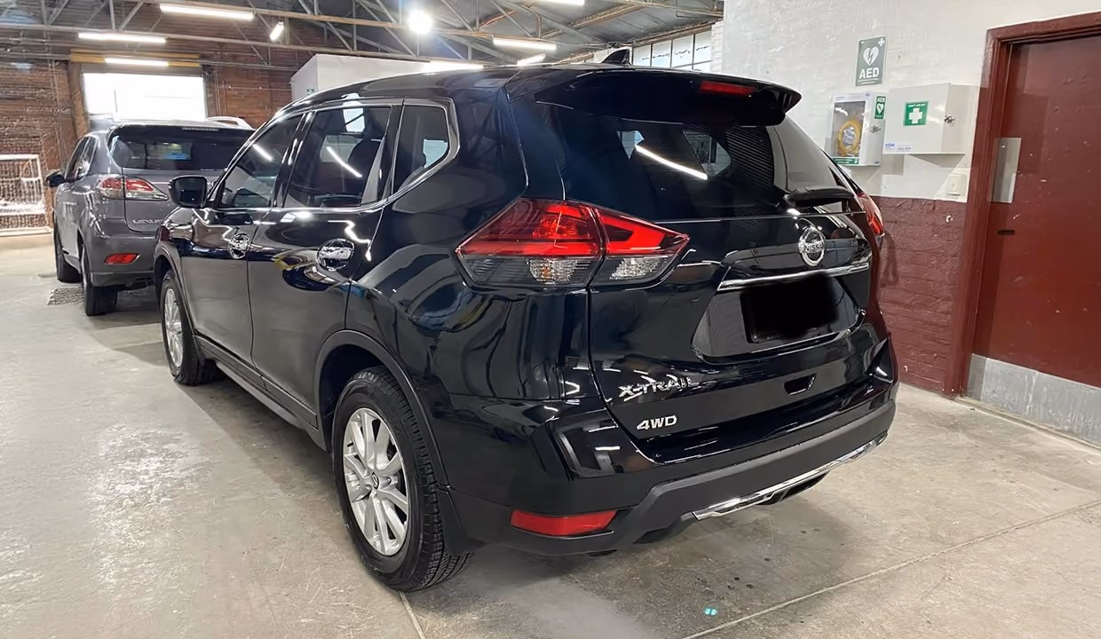 Shows a Nissan X-Trail after repair, completely restored with a new rear windshield, flawless tailgate, and perfectly aligned bumper and lighting.