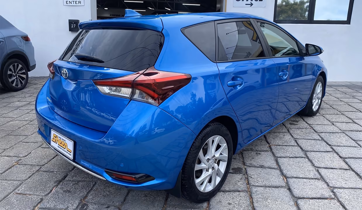 Displays a Toyota Yaris after repair, fully restored with a new tail light, flawless rear quarter panel, and a smooth, polished finish matching the original factory look.