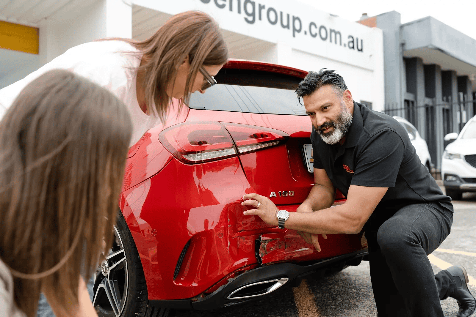 One of our mechanics explains to a client the nature of the damage to her car’s rear end, and what it will take to repair it.