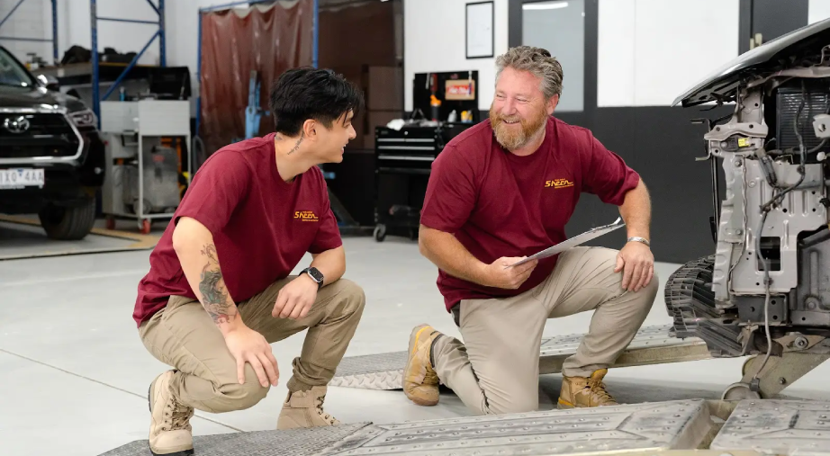 Sheen technicians assessing vehicle damage after insurance towing.