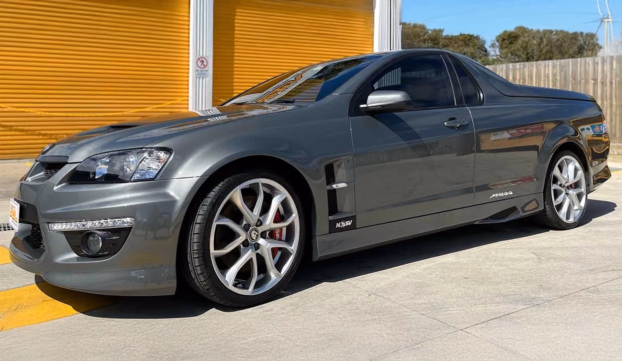 Side view of a grey Holden HSV Maloo ute after repair, with smooth, restored side panel and wheel arch, finished to a clean, factory-like condition.