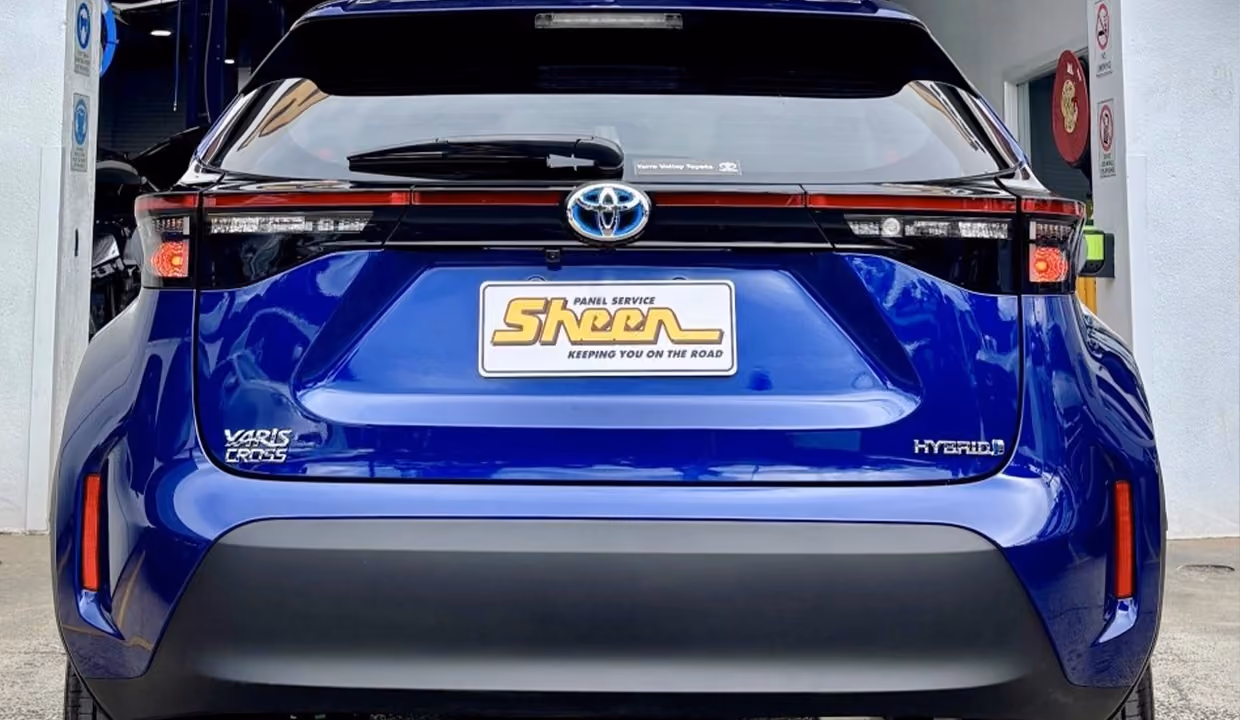 Rear view of a blue Toyota Yaris Cross after repair, with a smooth, restored rear bumper and clean, even finish.