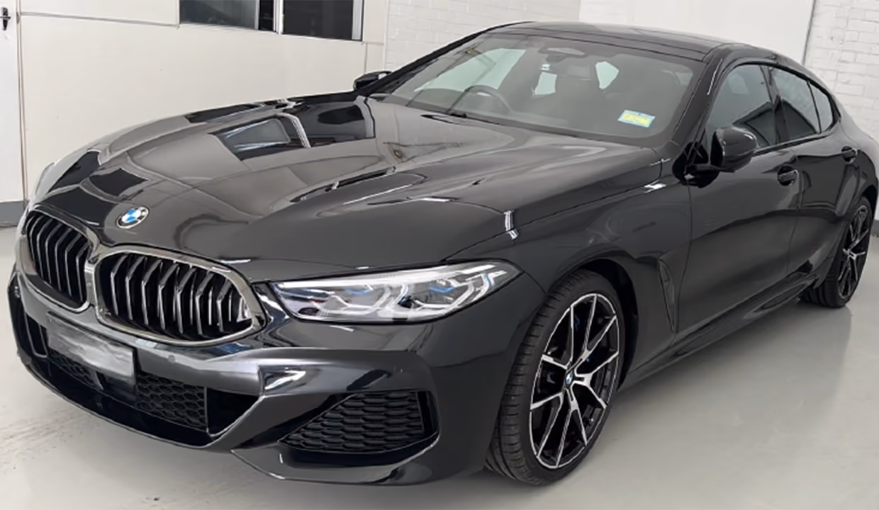 Front-side view of a black BMW 3 Series after repair, with smooth, aligned panels and a glossy, fully restored finish.
