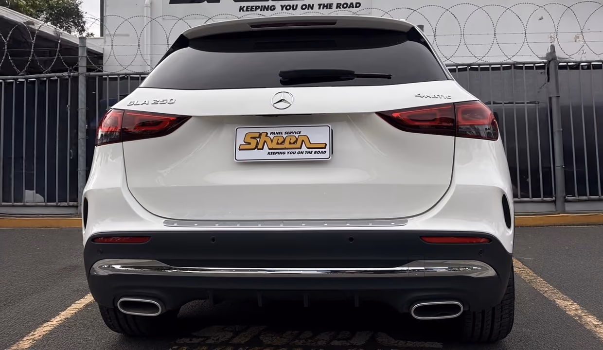 Rear view of a white Mercedes-Benz GLA 250 after repair, showing a perfectly restored tailgate and bumper with clean alignment and a smooth, factory-quality finish.