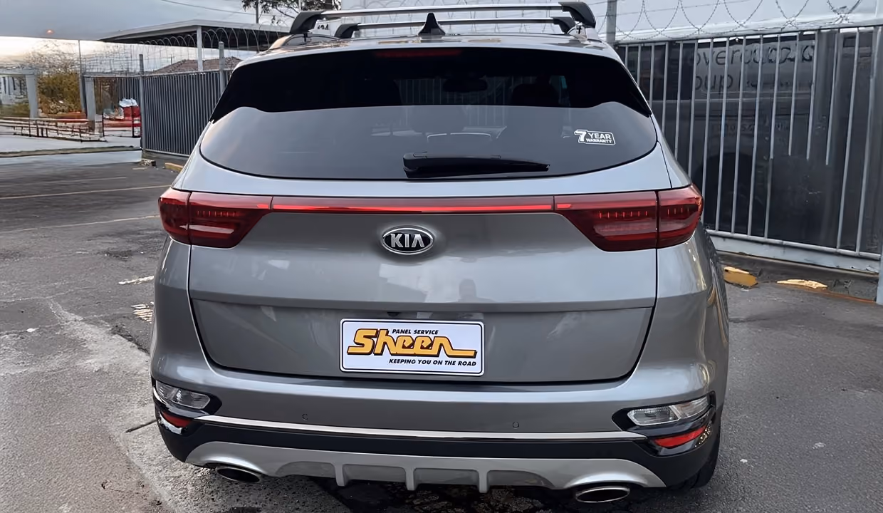 Rear view of a silver Kia Sportage after repair, showing a fully restored tailgate, new rear glass, and perfectly aligned bumper with a smooth, factory-quality finish.